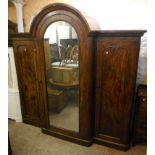 An 8' 4" Victorian mahogany triple wardrobe of massive proportions, with domed top and central