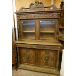 A 4' 7" 19th Century French oak two part dresser with broken swan neck pediment and moulded frieze