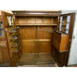 A 5' Compactum (brand) mahogany wardrobe with moulded cornice and fully fitted interior enclosed