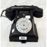 A mid 20th Century bakelite dial telephone