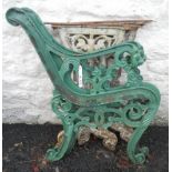 A pair of painted iron bench ends with lion mask scroll arms - sold with a pair of older cast iron