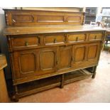 A 5' early 20th Century oak sideboard with, two drawers and pair of decorative panelled cupboard