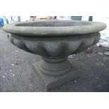 A 3' 2" diameter precast concrete two part garden urn set on a pedestal and plinth base