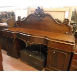 A 6' 8" Victorian mahogany serpentine breakfront sideboard with ornate carved raised back, three