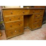 A 4' 8" Victorian stained wood kneehole desk with two frieze drawers and six flanking short drawers,