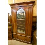 A 4' Victorian mahogany wardrobe with moulded cornice, hanging space enclosed by an arched mirror