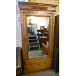 A 3' 6" late 19th Century continental pitch pine wardrobe with hanging space enclosed by a mirror