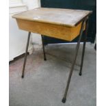 A vintage school desk with lift top and tubular steel frame