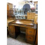 A 3' 8" Art Deco stained oak knee-hole dressing table with large bevelled mirror over, two frieze