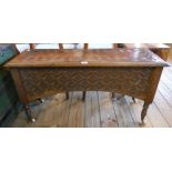 A 3' 6" Victorian carved oak lift-top chest with Gothic boss decoration to front and curved apron,