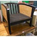 Two modern black painted wood framed armchairs with double rattan panel sides - no cushions