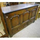 A 4' 8 1/2" antique oak mule chest with inlaid compass points to triple panelled front, over three