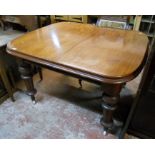 A Victorian mahogany extending dining table with rounded moulded edge and single leaf, set on