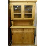 A 3' 10" waxed pine dresser with glazed top section and turned front supports, over two drawers