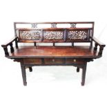 A 4' 6" antique Chinese stained hardwood bench with triple fretwork decorative figural panels