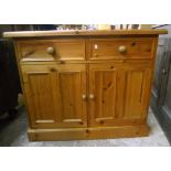 A 3' 6" modern polished pine dresser base with two short drawers and pair of panelled cupboard doors
