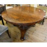 A 4' 2 1/2" diameter 19th Century rosewood breakfast table, set on a faceted tapered pillar and