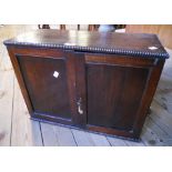 An early 20th Century mahogany two door cabinet with moulded beaded decoration