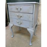 A painted bedside chest of three long drawers, set on shell carved cabriole legs