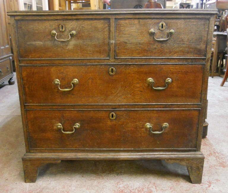 A 3' 1" early 19th Century oak chest of two short and two long graduated drawers, set on bracket