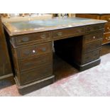 A 4' 6" early 20th Century mahogany twin pedestal desk with green leather inset top, three frieze
