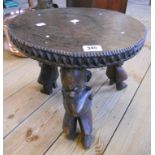 A 15" diameter Malawi carved hardwood stool with incised decoration and decorative frieze, set on