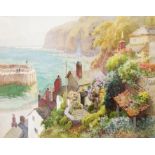 Ernest William Haslehurst: a framed watercolour, depicting a view of Clovelly with cottages and