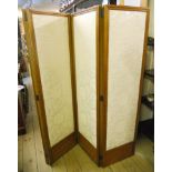 An early 20th Century polished wood four fold dressing screen with later floral cut jacquard ivory