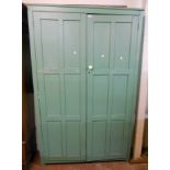 A 4' 1" painted mixed wood narrow scullery cupboard with five shelves enclosed by a pair of panelled