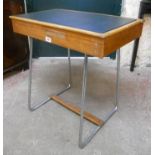 A retro stained wood school desk with vinyl inset lid, set on chrome plated tube steel supports