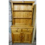 A 36" modern polished pine two part dresser with barley twist decorated open plate rack top, over