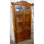 A 3' 1" polished stained wood two part corner cabinet by Pierre Fontaine, with moulded cornice and