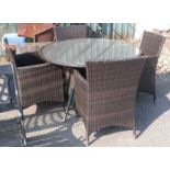 A patio set of circular table and four chairs with woven plastic finish