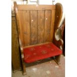 A 3' stained pine tavern settle with panelled back, shaped sides and upholstered seat