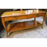 A 3' 8" polished stained wood coffee table by Pierre Fontaine with two shaped frieze drawers,