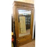 A 3' 3" late 19th Century continental pitch pine wardrobe with hanging space enclosed by a mirror