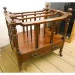 A mid 19th Century mahogany Canterbury with turned supports and single drawer under, set on