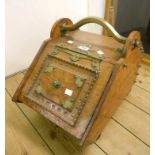 A Victorian oak slope fronted coal box with ornate pierced brass hinge and decorative lid - complete