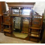 A 4' 8 1/2" Edwardian walnut overmantel with bevelled mirror plates, spindle gallery, turned