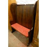 A 3' 9" mid 20th Century stained oak tavern settle by Lethbridge, with panelled back, shaped sides