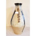 A 16" studio pottery vase of bulbous form with mottled decoration