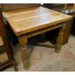 An oak drop-leaf dining table with turned supports and X-stretcher