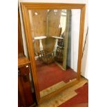A large polished pine framed wall mirror