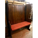 A 3' 9 1/2" mid 20th Century stained oak tavern settle by Lethbridge, with panelled back, shaped