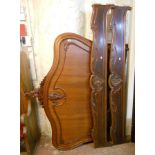 A late 19th Century French walnut ornate double bedstead with carved and moulded decoration to