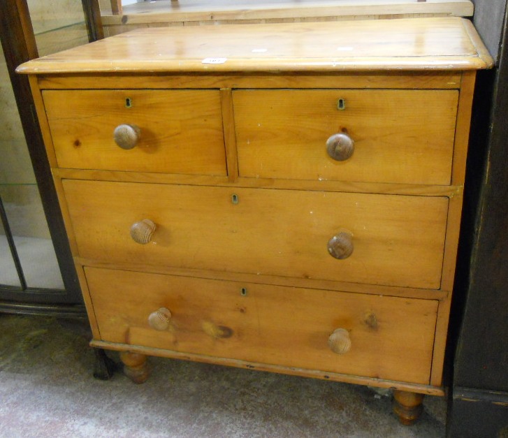 A 34" Victorian stained pine chest of two short and two long graduated drawers, set on turned feet