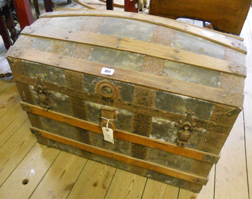 A 30½" Victorian metal and wood bound dome top travelling trunk with tray fitted interior and