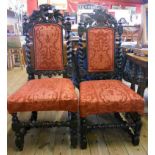 Two similar Victorian ebonised oak framed panel back dining chairs with flanking barley twist