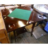 A 32" Edwardian mahogany envelope card table, set on slender square tapered supports with