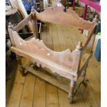 A 31" 19th Century pitch pine stand with shaped front and back, turned finials and supports with